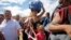 A woman carrying a bundle on her head wait in line to cross the border into Colombia through the Simon Bolivar bridge in San Antonio del Tachira, Venezuela, July 17, 2016.
