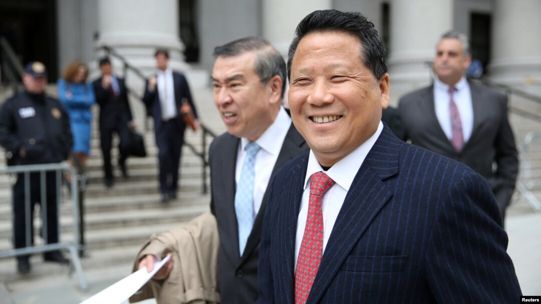 FILE - Macau billionaire real estate developer Ng Lap Seng, right, accused of bribing former United Nations General Assembly president John Ashe, exits the Manhattan U.S. District Courthouse in New York, April 7, 2017. 