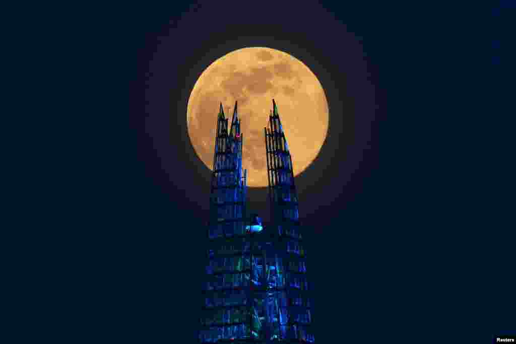 The Pink Supermoon rises over the Shard skyscraper in London, April 7, 2020.