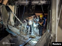 Rescuers carry a victim at a site of a Russian missile strike in Kryvyi Rih, Ukraine, in this photo released on Aug. 27, 2024, by the State Emergency Service of Ukraine.