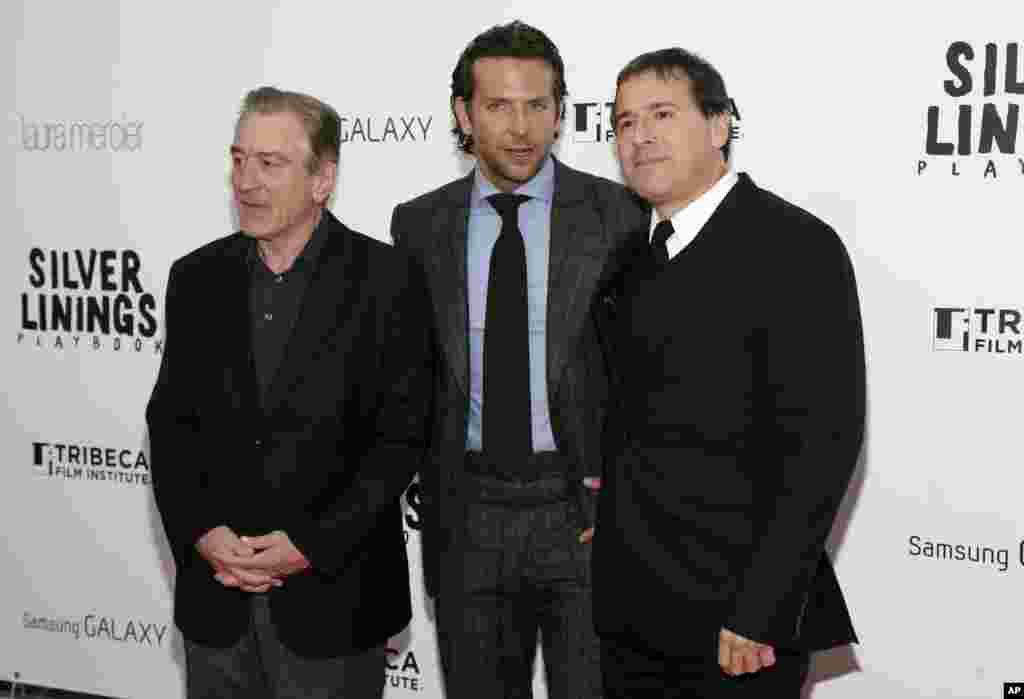 Actors Robert DeNiro, left, Bradley Cooper, and Director David O. Russell, right, attend the premiere of "Silver Linings Playbook," at the Ziegfeld Theatre in New York, November 12, 2012. 