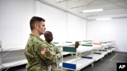 US officers inspect the accommodation for the soldiers in the Flaeming barracks for the military exercise 'Defender 2020', in Brueck, Germany, Wednesday, Feb. 26, 2020. The exercise with 37,000 participants from a total of 18 nations will take place…