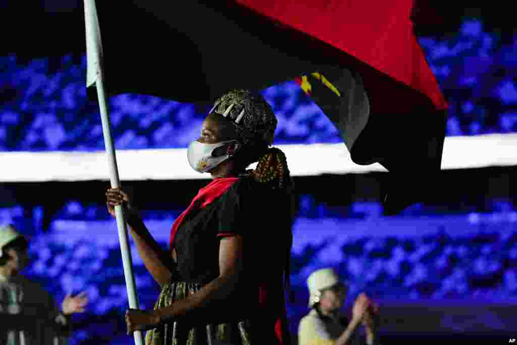 Natalia Santos of Angola, carry her country&#39;s flag during the opening ceremony in the Olympic Stadium at the 2020 Summer Olympics, July 23, 2021, in Tokyo, Japan.