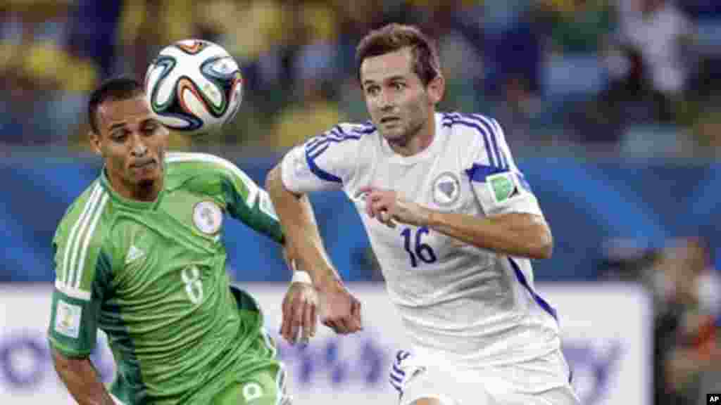 Nigeria's Peter Odemwingie, left, chases the ball with Bosnia's Senad Lulic.