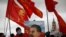 FILE - A supporter of the Russian Communist Party holds a portrait of Soviet leader Josef Stalin during a procession marking the anniversary of the 1917 Bolshevik Revolution, in Red Square in Moscow, Russia, Nov. 7, 2020. 
