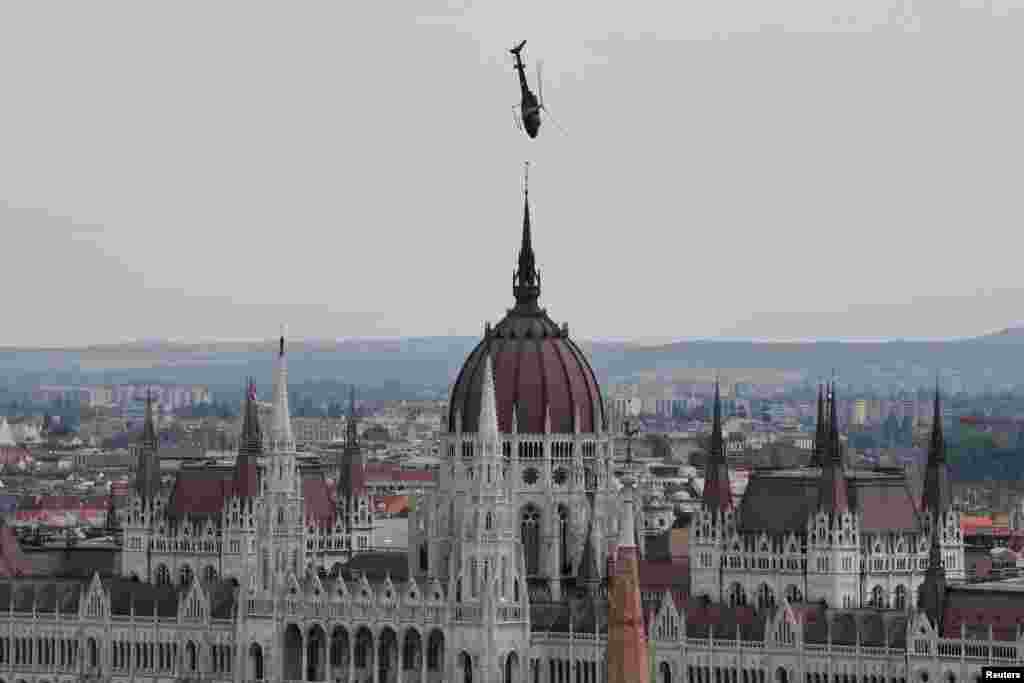 The Hungarian Air Force’s AS 350 helicopter flies low during the St. Stephen's Day celebration in Budapest, Hungary.