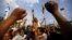 A Hindu activist (C) holding a trident chants slogans near a police line during a protest rally that tries to break through a restricted area near parliament, in Kathmandu, Nepal, Sept.1, 2015.