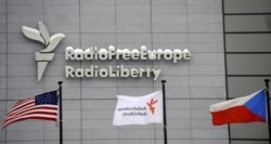 FILE - The headquarters of Radio Free Europe/Radio Liberty (RFE/RL) is seen with the United States, RFE/RL and the Czech Republic flags in the foreground, in Prague, Jan. 15, 2010.