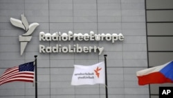 FILE - The headquarters of Radio Free Europe/Radio Liberty (RFE/RL) is seen with the United States, RFE/RL and the Czech Republic flags in the foreground, in Prague, Jan. 15, 2010.