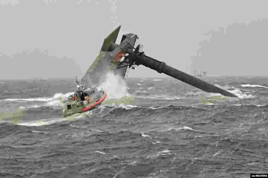 A Coast Guard Station Grand Isle boatcrew heads toward a capsized 175-foot commerical lift boat while searching for people in the water 8 miles (about 13 km) south of Grand Isle, Louisiana, April 13, 2021. (U.S. Coast Guard/Handout)