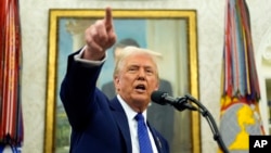 U.S. President Donald Trump speaks as Tulsi Gabbard is sworn in as the Director of National Intelligence in the Oval Office of the White House in Washington, Feb. 12, 2025.