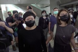 FILE - Bao Choy, a freelance producer with RTHK, leaves court after she was found her guilty of making false statements to obtain data for a documentary, in Hong Kong, April 22, 2021.