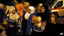 FILE - Syrians wait to be evacuated from the besieged town of Madaya, northwest of Damascus, Jan. 11, 2016. They were among about 400 people needing immediate life-saving treatment for malnourishment and other medical conditions.