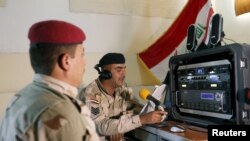 Iraqi soldiers work at a radio station at Makhmour base, April 17, 2016. The Iraqi army has set up a radio station at its base in Makhmour broadcasting into areas south of Mosul controlled by Islamic State militants. 