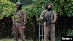 Indian security personnel stands guard near a vote counting centre for assembly election in Srinagar, Oct. 8, 2024.