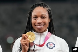 Allyson Felix, of United States, poses with her gold medal for the women's 4 x 400-meter relay at the 2020 Summer Olympics, Aug. 7, 2021, in Tokyo.