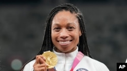 Allyson Felix, of United States, poses with her gold medal for the women's 4 x 400-meter relay at the 2020 Summer Olympics, Aug. 7, 2021, in Tokyo.