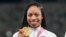 Allyson Felix, of United States, poses with her gold medal for the women's 4 x 400-meter relay at the 2020 Summer Olympics, Aug. 7, 2021, in Tokyo.