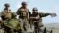 FILE - Soldiers from U.S. Marines and Japan's Ground Self-Defense Force attend their joint exercises that are intended to recover an island in San Clemente Island, California, in this photo taken and provided by Kyodo, Feb. 9, 2013. 