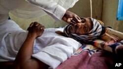 FILE - A patient with hepatitis is treated at a hospital in El Sereif village, North Darfur, Sudan, May 13, 2013.