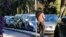FILE - A prostitute waits for a client in a street of Nice southern France, Nov. 21, 2013. France’s government is pushing one of Europe’s toughest laws against prostitution and sex trafficking, and other countries are watching closely.