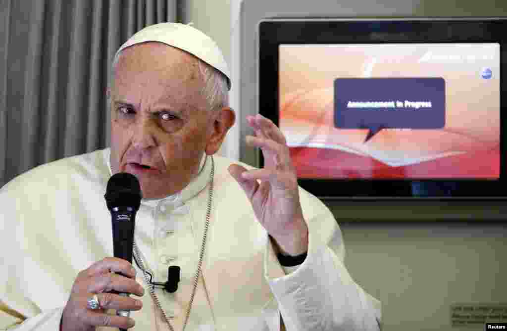 Pope Francis answers questions from a journalist during the flight from Colombo, Sri Lanka, to Manila in the Philippines, Jan. 15, 2015.