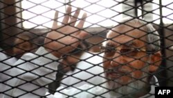 FILE - Egyptian Muslim Brotherhood's general guide, Mohamed Badie, at the trial of Brotherhood members in February 2014 near Cairo's Turah prison.