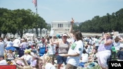 Tens of thousands of young people on the National Mall celebrate the 100th anniversary of Girl Scouts of the United States