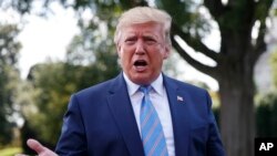 FILE - President Donald Trump speaks to the media before leaving the White House in Washington.