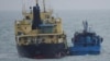 FILE - This Feb. 16, 2018, file photo released by Japan's Ministry of Defense shows what it says North Korean-flagged tanker Yu Jong 2, left, and Min Ning De You 078 lying alongside in the East China Sea performing a ship-to-ship transfer. 