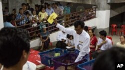 Votes are counted in an unfinished building being used as a polling station in Yangon, Myanmar, Nov. 8, 2015.