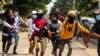 Protesters carry an injured comrade during a demonstration against the military coup in Yangon&#39;s Thaketa township, Myanmar.