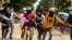 Protesters carry an injured comrade during a demonstration against the military coup in Yangon's Thaketa township, Myanmar.