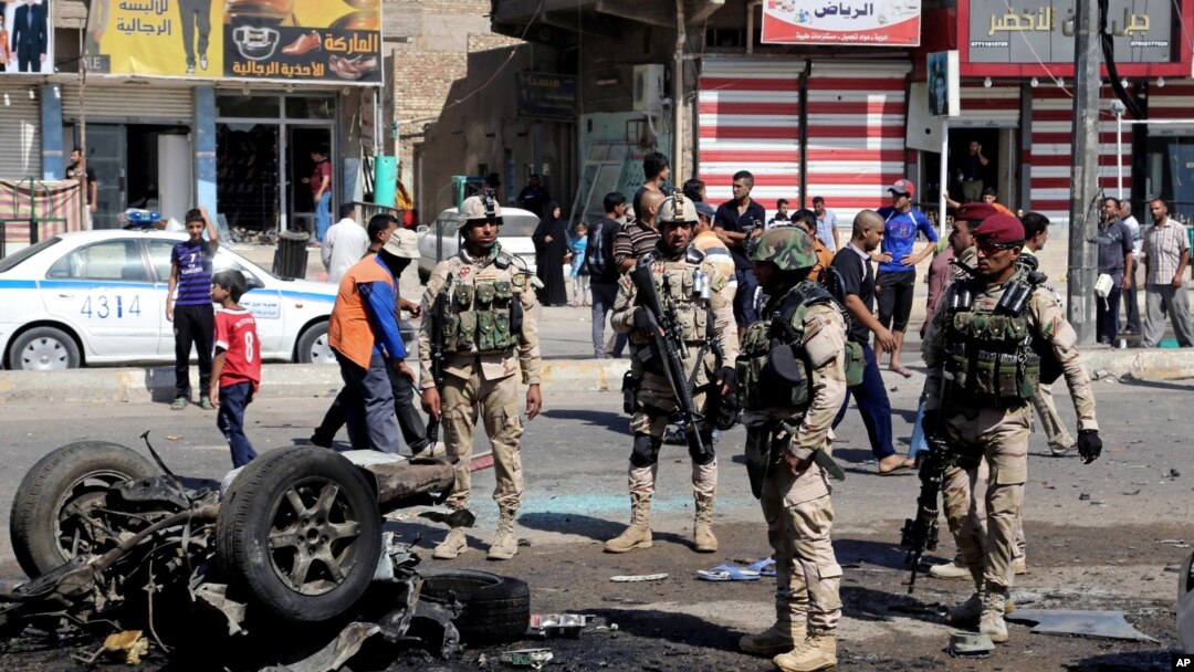Warga sekitar dan pasukan keamanan memeriksa lokasi serangan bom mobil di Sadr City, Baghdad, 28 Agustus 2013.