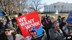 FILE - Union members and other federal employees stop in front of the White House in Washington during a rally to call for an end to the partial government shutdown, Jan. 10, 2019.