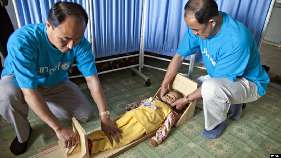 FILE - UNICEF staff measure a girl's height to see if she is stunted in a village health clinic of South Hamgyong province, North Korea.