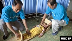 FILE - UNICEF staff measure a girl's height to see if she is stunted in a vellage health clinic of South Hamgyong province, North Korea, June 15, 2012. 