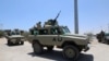 FILE - Burundian African Union Mission in Somalia (AMISOM) peacekeepers travel on armored vehicle as they leave the Jaale Siad Military academy after being replaced by the Somali military in Mogadishu, Somalia, Feb. 28, 2019.