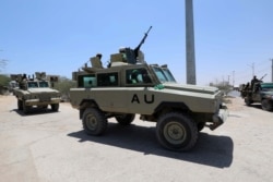 FILE - Burundian African Union Mission in Somalia (AMISOM) peacekeepers travel on armored vehicle as they leave the Jaale Siad Military academy after being replaced by the Somali military in Mogadishu, Somalia. Feb. 28, 2019.