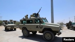 FILE - Burundian African Union Mission in Somalia (AMISOM) peacekeepers travel on armored vehicle as they leave the Jaale Siad Military academy after being replaced by the Somali military in Mogadishu, Somalia. Feb. 28, 2019. 