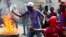 FILE - Demonstrators set barricade on fire during a violent protest in Port-au-Prince, Haiti, Nov. 23, 2018. Thousands of demonstrators clashed with police in Haiti's capital, demanding the ouster of President Jovenel Moise. 