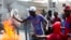 FILE - Demonstrators set barricade on fire during a protest in Port-au-Prince, Haiti, Nov. 23, 2018. Thousands of demonstrators clashed with police in Haiti's capital, demanding the ouster of President Jovenel Moise. 