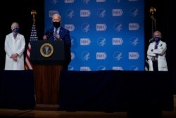 President Joe Biden speaks during a visit to the Viral Pathogenesis Laboratory at the National Institutes of Health, Thursday, Feb. 11, 2021, in Bethesda, Md. National Institutes of Health Director Francis Collins, left, and Dr. Anthony Fauci.