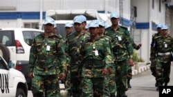 UN troops walk inside the UN Headquarters in Abidjan, Ivory Cost, Friday, Dec. 31, 2010. The United Nations is warning supporters of incumbent leader Laurent Gbagbo that an attack on the hotel where the internationally recognized winner of last month's el