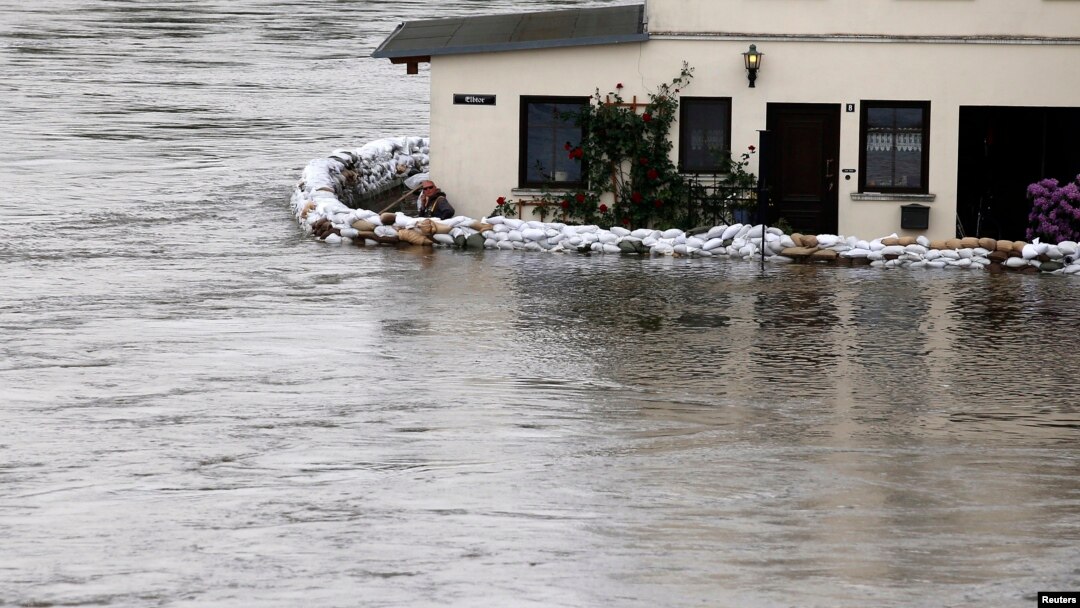 Seorang warga memeriksa karung-karung pasir penahan banjir di Sungai Elbe di kota Magdeburg, Jerman (9/6).
