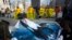 FILE - Greenpeace activists unfurl a banner showing a whale during a rally demanding the release of illegally caught orcas and beluga whales from so-called 'whale prisons' off the coast of Russian Far East, in Moscow, Russia, April 2, 2019.