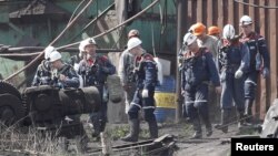 Miners and rescuers walk at the coal mine of the Skhidkarbon company following a gas explosion, in Yurievka, near the separatist-controlled city of Luhansk, Ukraine, April 26, 2019.