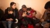 In this Feb. 12, 2020 photo, Malak Saad Dakhel, an 11 year-old Yazidi, is overwhelmed by journalists and well-wishers as her family tries to comfort her after her escape from Syria, in Sharia, Iraq. She was captured by Islamic State militants in 2014.