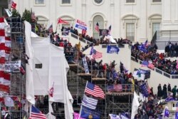 FILE - Trump supporters gather outside the Capitol in Washington, Jan. 6, 2021.