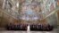 FILE - Pope Francis poses in the Sistine Chapel with members of the diplomatic corps accredited to the Holy See at the end of an audience for the traditional exchange of New Year greetings at the Vatican, Jan. 9, 2017.